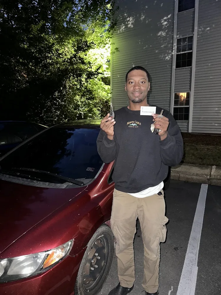 Customer holding a programmed car key at night